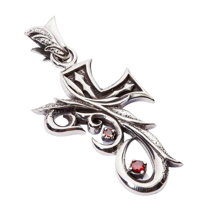Angled view of the tribal gothic cross pendant showing the curved design and red stones.