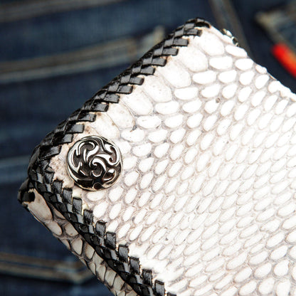 A close-up of the ornate silver-tone snap on the white cobra snake wallet.