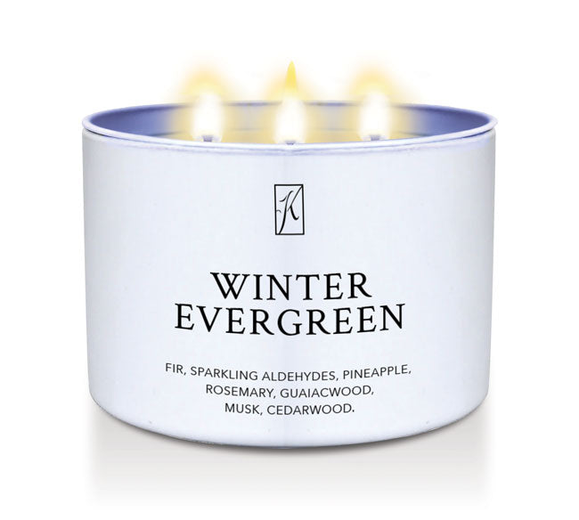Candle in a white container labeled 'Winter Evergreen' with flames on a white background