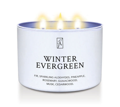 Candle in a white container labeled 'Winter Evergreen' with flames on a white background