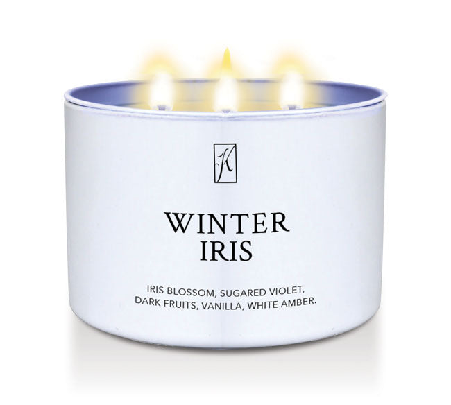 Candle in a white container labeled 'Winter Iris' with a logo on a white background