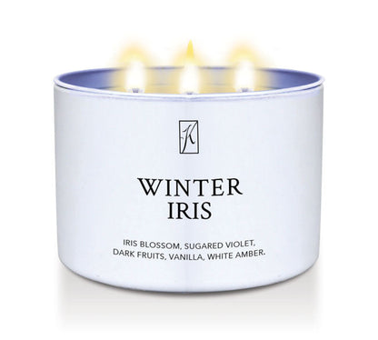 Candle in a white container labeled 'Winter Iris' with a logo on a white background