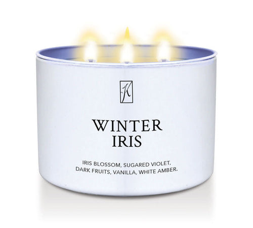 Candle in a white container labeled 'Winter Iris' with a logo on a white background