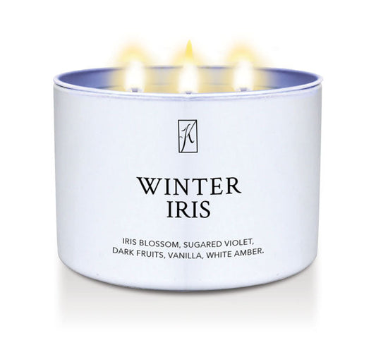 Candle in a white container labeled 'Winter Iris' with a logo on a white background