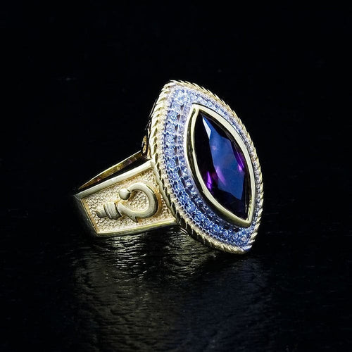 An angled view of the women's gold amethyst bishop ring, showing the crosier symbol on the 14K gold-plated band.