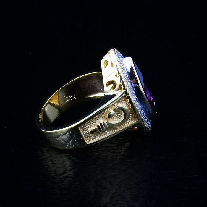 A side detail shot of the gold-plated sterling silver bishop ring, focusing on the handcrafted crosier emblem.